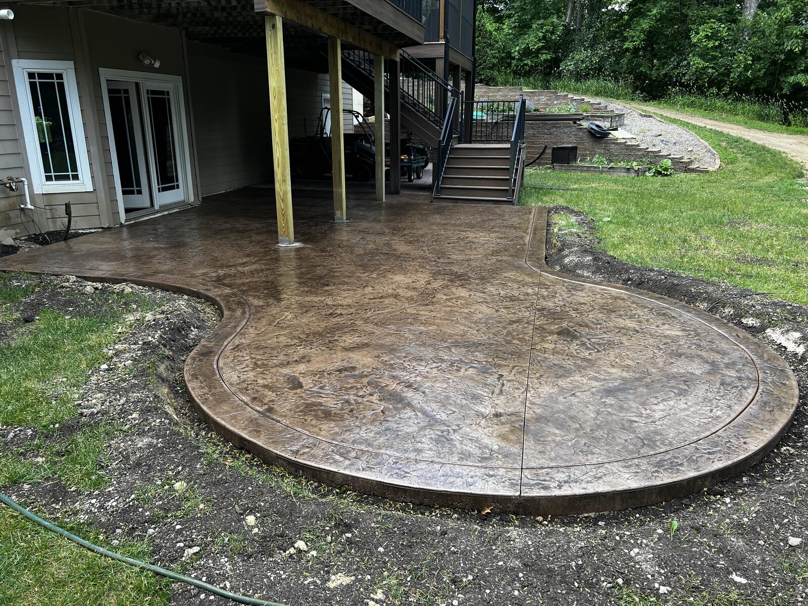 Stamped concrete pool deck with cobblestone texture in Minnesota